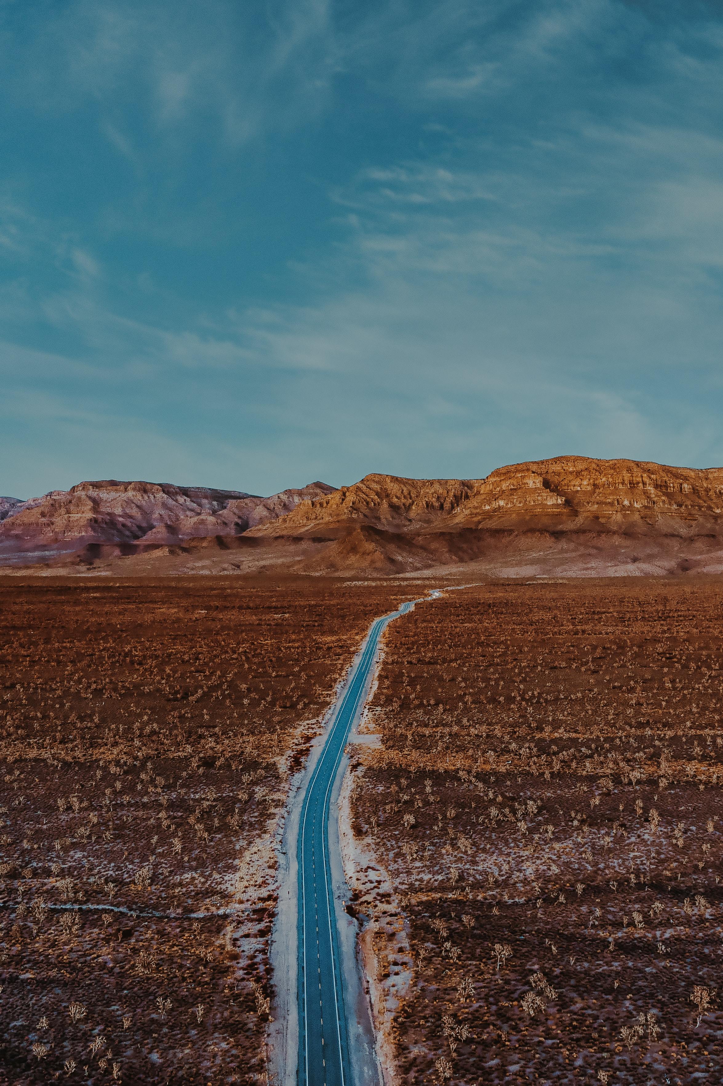 aerial-photo-of-paved-road-through-the-desert