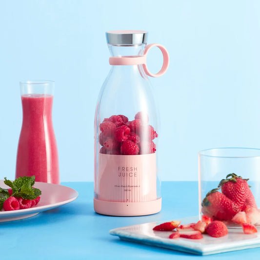 portable natural juice blender pink with rasberry and strawberry ready to going into the blender